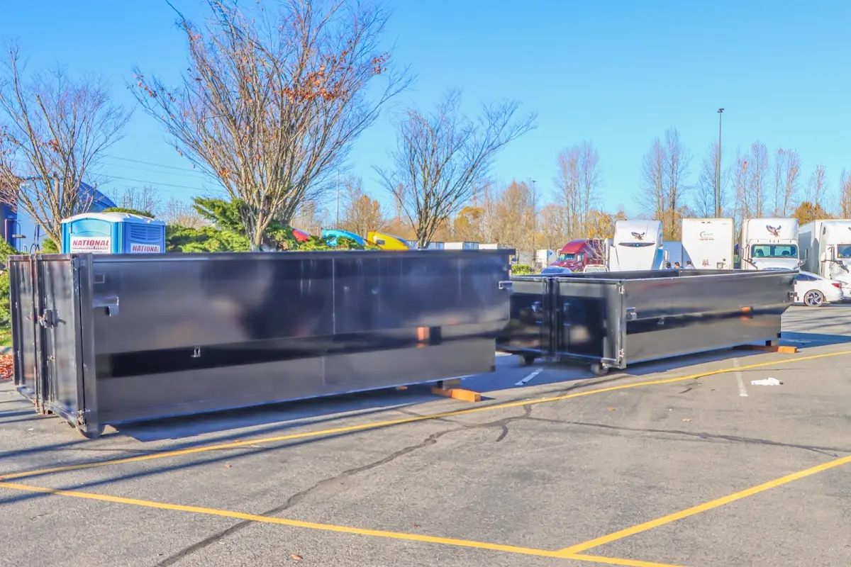 Professional dumpster rental service with roll-off container on residential driveway in Pelican Bay